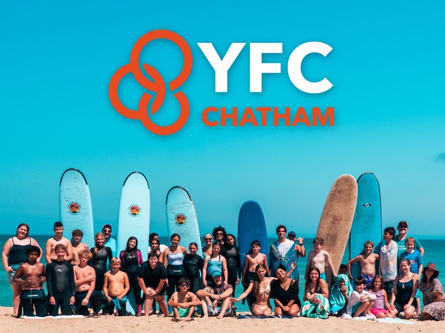 YFC Chatham logo above students and leaders with surfboards at YFC Surf Day